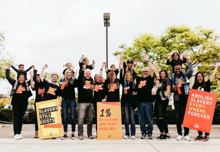 group of people holding signs at a walk for freedom.