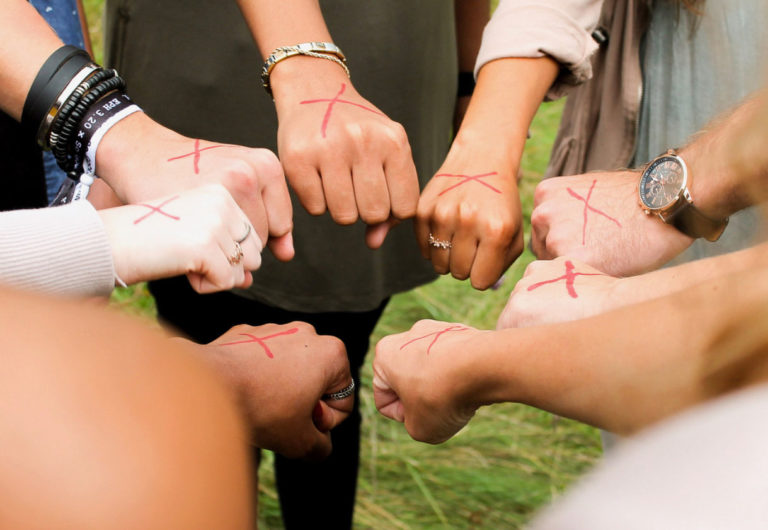 Group of peoples hand in a circle.