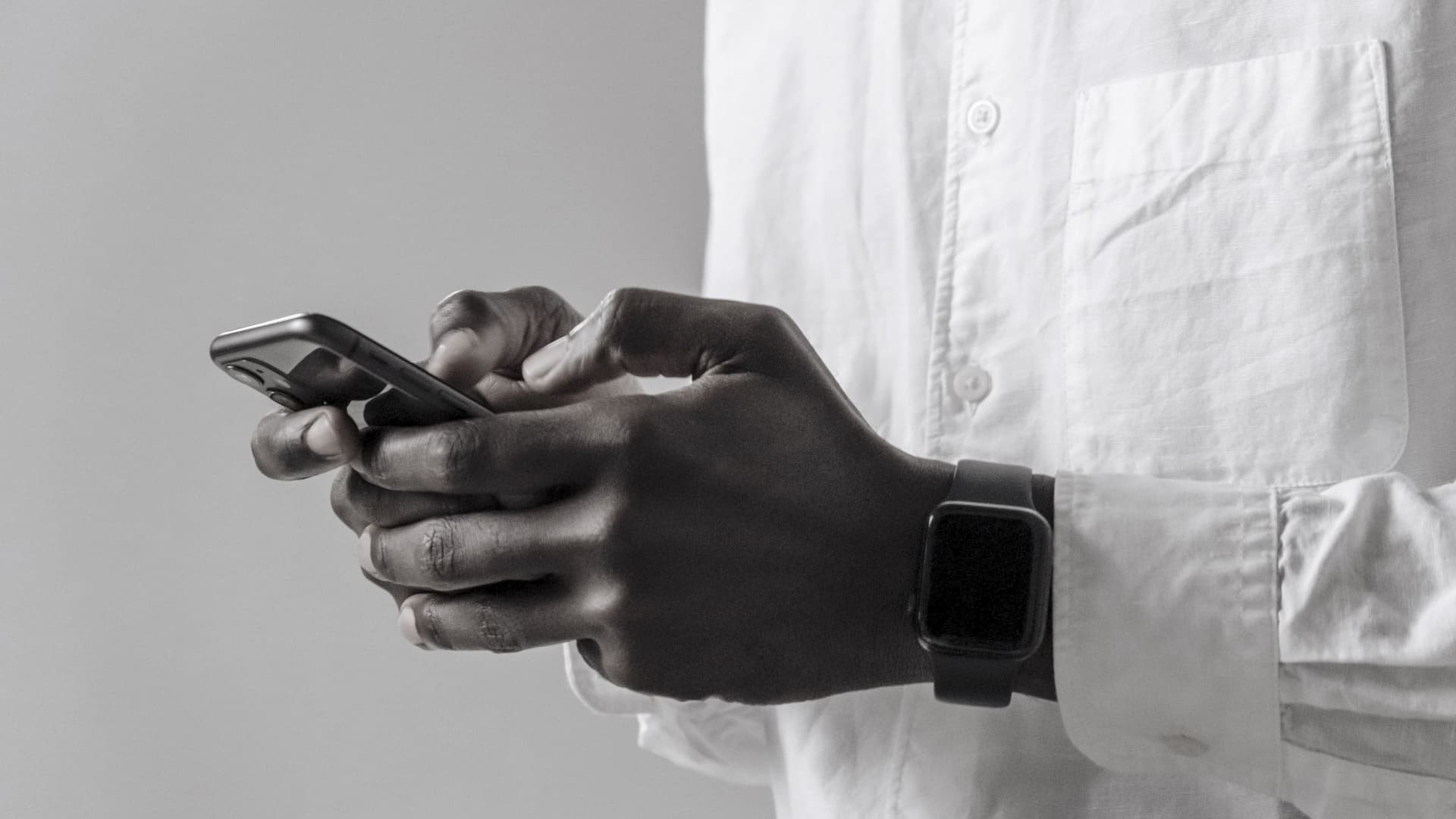 Person holding a smartphone, representing the ability to support human trafficking prevention through community action and giving.